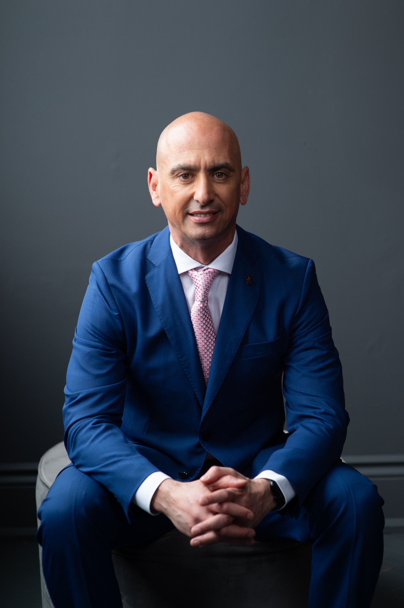 Norbert Borosiu seated in a blue suit
